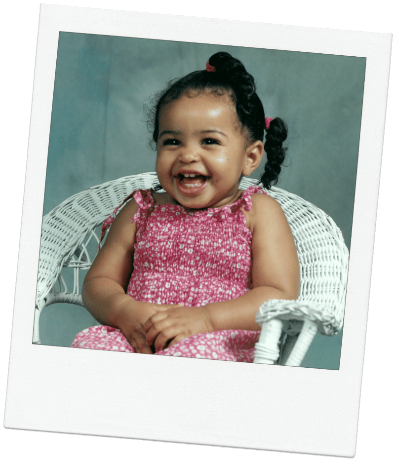 Girl toddler in pink dress laughing